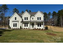 Newly constructed two-story home boasts classic design, gabled roofs, and a covered front porch at 1875 Rock Hill Church Rd # 4, Matthews, NC 28104