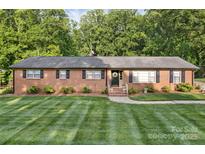 Charming single-story brick home with black shutters and a beautifully manicured lawn at 216 Delview Dr, Cherryville, NC 28021