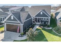 Gray house with a brown garage and American flag at 112 Sisters Cove Ct, Mooresville, NC 28117