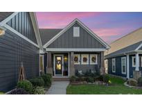 Gray two-story home with a welcoming front porch and landscaping at 112 Sisters Cove Ct, Mooresville, NC 28117