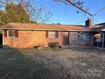 Charming brick front exterior with well-maintained lawn, mature trees, and a welcoming front porch at 2040 Ne 25Th Street Dr, Hickory, NC 28601