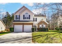 Two-story brick and vinyl home with a two-car garage and well-manicured lawn at 3116 S Legacy Park Blvd, Fort Mill, SC 29707