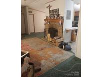 Cozy living room featuring a fireplace and a large area rug at 5084 Beaver Dam Way, Bessemer City, NC 28016