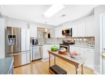 Modern kitchen featuring stainless steel appliances and granite countertops at 9149 Washam Potts Rd, Cornelius, NC 28031