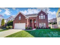 Brick two-story house with a large yard and attached garage at 98 Poplar Woods Dr, Concord, NC 28027