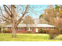 Charming single story brick home with a well-maintained lawn and mature trees at 1008 Candlewood Ln, Rock Hill, SC 29730