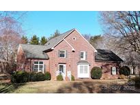 Charming two-story brick home with a well-maintained lawn and traditional architectural details at 104 Woodvale Cir, Lincolnton, NC 28092