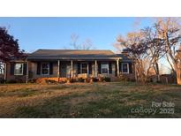 Brick ranch home with covered porch and landscaped yard at 1308 Princeton Ave, Gastonia, NC 28054