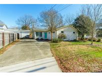 Ranch home with carport, fenced yard, and mature trees at 549 Spring Sw St, Concord, NC 28025