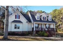 Charming home with a inviting front porch and well-maintained landscaping at 8046 Lucky Creek Ln, Denver, NC 28037