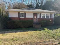 Brick and siding ranch home with well-maintained lawn at 112 Adcock St, Belmont, NC 28012