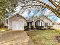 Charming single-story home with a well-maintained front yard and attached one car garage at 1805 Tufnell Ct, Charlotte, NC 28262