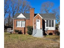 Brick ranch house with a white door, gray steps, and a yard at 602 W Graham St, Shelby, NC 28150