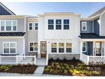 Charming townhome with modern white siding, large windows, and a well-manicured front yard at 8912 Connover Hall Ave, Charlotte, NC 28215