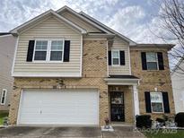 Brick and shingle two-story house with a two-car garage at 9514 Currier Rd, Charlotte, NC 28215