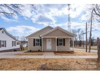 Tan house with white trim and a covered porch at 17 N Arlington St, Salisbury, NC 28144