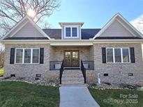 Brick home with double front doors and a landscaped front yard at 496 19Th Avenue Nw Cir, Hickory, NC 28601