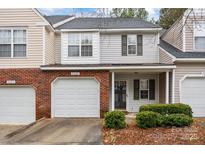 Brick front townhouse with attached garage and landscaping at 2022 University Heights Ln, Charlotte, NC 28213