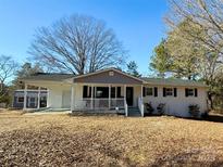 White brick ranch house with gray accents, covered porch, and detached garage at 3654 Lynwood Dr, Lancaster, SC 29720