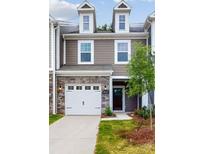 Charming two-story home features stone accents, attached garage, and welcoming entryway at 4031 Lawnview Dr, Charlotte, NC 28269