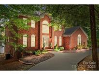 Brick home with a large driveway and landscaping at 800 Lakeview Shores Loop, Mooresville, NC 28117