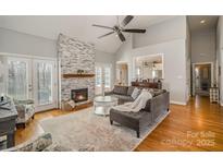 Inviting living room featuring a stone fireplace and hardwood floors at 180 Sink Farm Rd, Mooresville, NC 28115