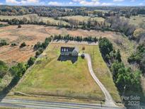Stunning aerial view of a charming home nestled on a sprawling, picturesque lot surrounded by lush trees and landscaping at 3798 Red Doc Rd, Lancaster, SC 29720