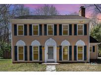 Charming two-story home with a classic design, black shutters, and inviting curb appeal at 5328 Caradon Dr, Charlotte, NC 28227
