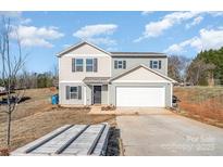 Two-story house with attached garage and landscaping at 114 Four Andrews Dr, Harmony, NC 28634