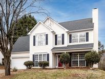 Two-story house with white siding, gray roof, and red front door at 11813 Fox Glen Rd, Charlotte, NC 28269