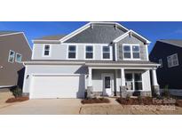 Two-story house with gray siding, white trim, and a covered front porch at 2612 Clipper Nw Ct, Concord, NC 28027