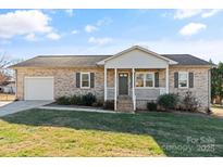 Charming brick home with a cozy front porch and well-maintained lawn at 2505 Ashford Dr, Newton, NC 28658