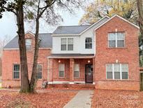 Two-story brick home with covered porch and mature trees at 5846 Hanna Ct, Charlotte, NC 28212