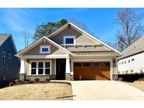 New craftsman style home with a brown door and stone accents at 166 Fulworth Nw Dr # 67, Concord, NC 28027