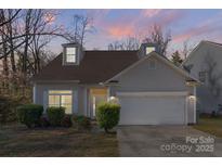 Charming home with dormer windows, manicured bushes and a two-car garage at 6707 Brachnell View Dr, Charlotte, NC 28269