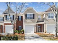 Charming townhouse featuring a one-car garage and well-maintained landscaping at 7122 Abbotts Glen Dr, Charlotte, NC 28212