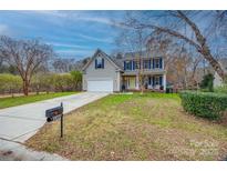 Charming two-story home with a well-manicured lawn and inviting front porch at 1345 Shimmer Light Cir, Rock Hill, SC 29732