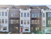 Modern townhome exterior with gray and white siding, black brick accents, and a striking orange front door at 3614 S Tryon St # 18, Charlotte, NC 28217