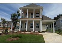 Beautiful two-story home features a large front porch with white columns and attached carport at 7392 Deer Hollow Rd # 27, Sherrills Ford, NC 28673