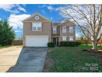 Charming two-story home featuring a well-manicured front yard and a two-car garage, perfect for a growing Gathering at 1114 Fenwick Ct, Clover, SC 29710
