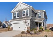 Two-story house with gray siding, white trim, and a two-car garage at 16042 River Tree Ln, Charlotte, NC 28278