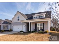 Charming home featuring a two-car garage, covered porch, and landscaped yard at 3611 Whitney Way, Terrell, NC 28682