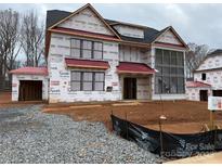 Newly constructed two-story home with gray siding and a red roof, currently for sale at 1015 Kendall Dr # 4, Wesley Chapel, NC 28173