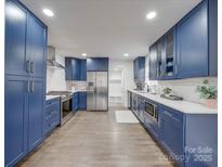 Modern kitchen with stainless steel appliances and blue cabinetry at 1330 Mulberry Ave, Charlotte, NC 28216