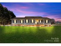 Charming ranch home with brick accents and a well-manicured lawn at 135 Rumple Hill Dr, Statesville, NC 28677