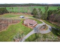 Beautiful aerial view of the brick home, nestled on a sprawling lot at 158 White Rd, Wadesboro, NC 28170