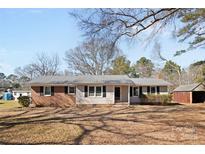 Charming one-story home with a metal roof, brick accents, and a well-maintained yard at 440 Providence Rd, Lancaster, SC 29720