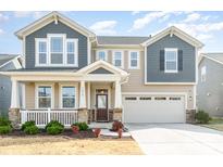 Two-story house with gray and beige siding, a stone facade, and a two-car garage at 1218 Raelea Dr, Indian Trail, NC 28079