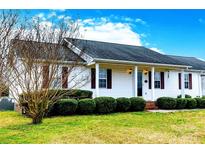 Charming single-story home with white siding, dark shutters, and a well-manicured front lawn, creating a welcoming curb appeal at 1976 Mcilwain Rd, Lancaster, SC 29720