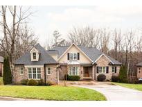 Brick home with a two-car garage and landscaped lawn at 2349 Shiny Leaf Dr, Denver, NC 28037